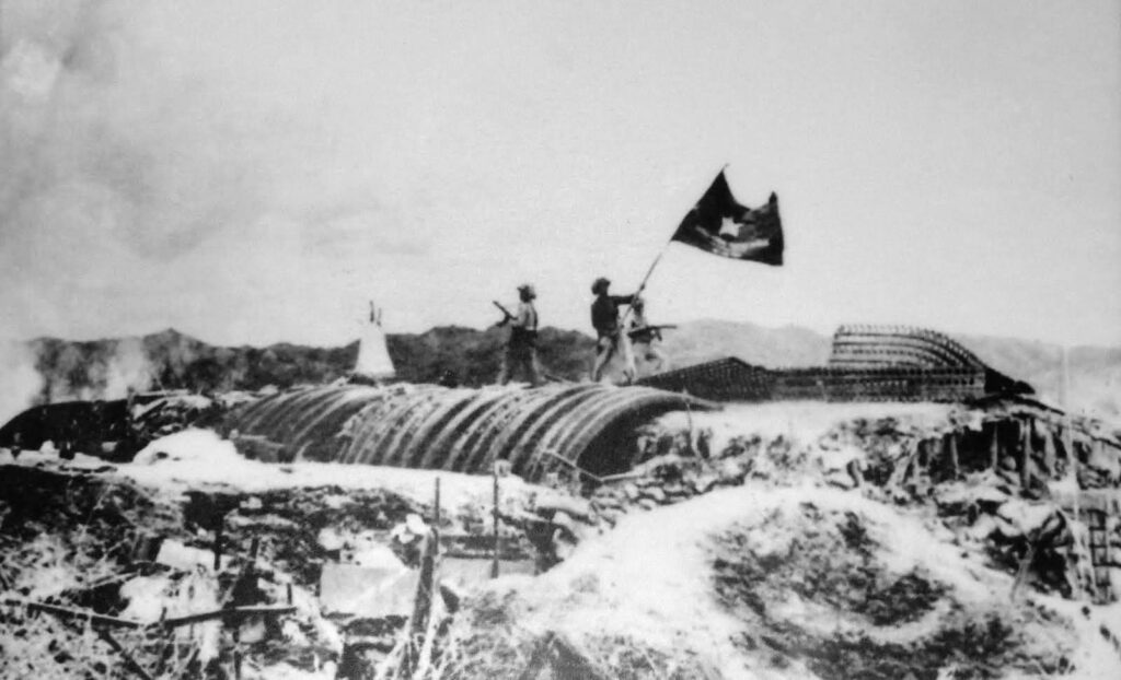 Viet Minh troops planting their flag over the captured French headquarters at Dien Bien Phu, May 7, 1954.